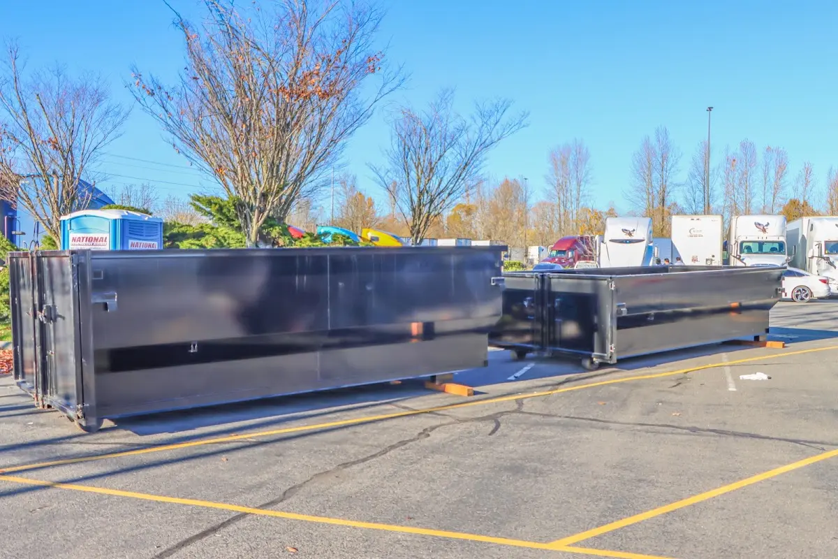 Professional dumpster rental service with roll-off container on residential driveway in Dobbs Ferry